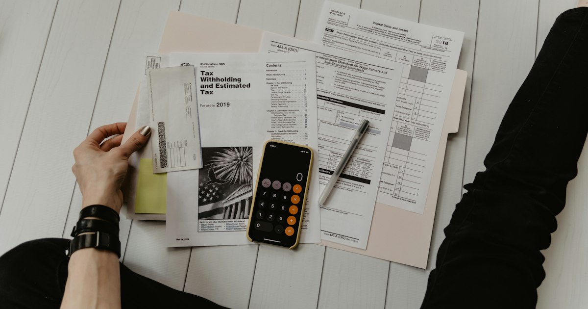 Calculadora e documentos sobre a mesa para cálculo de verbas trabalhistas